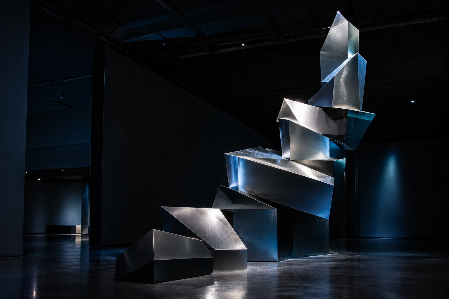 Rising geometric sculpture in a dark architectural space